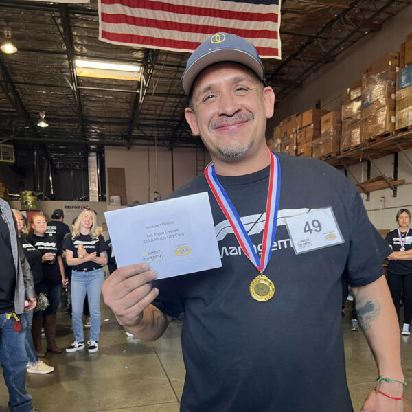 Oakmont employee receiving recognition certificate and medal.