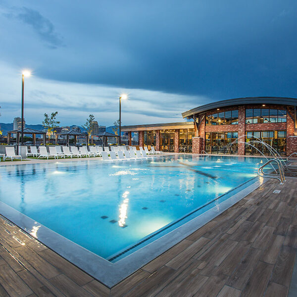 4th West rooftop pool with lounge chairs and bright lights.